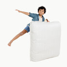 Meadow (on sale) / Square@kid holding up the meadow square floor cushion