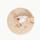 Millet / Circle@overhead of kid sitting on the millet circle quilted mat