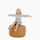 Ochre (on sale) / Circle@Kid sitting on the Ochre Circle Pouf