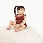 Ivory / Square@Little girl playing on the Ivory Mini Square Quilted Mat