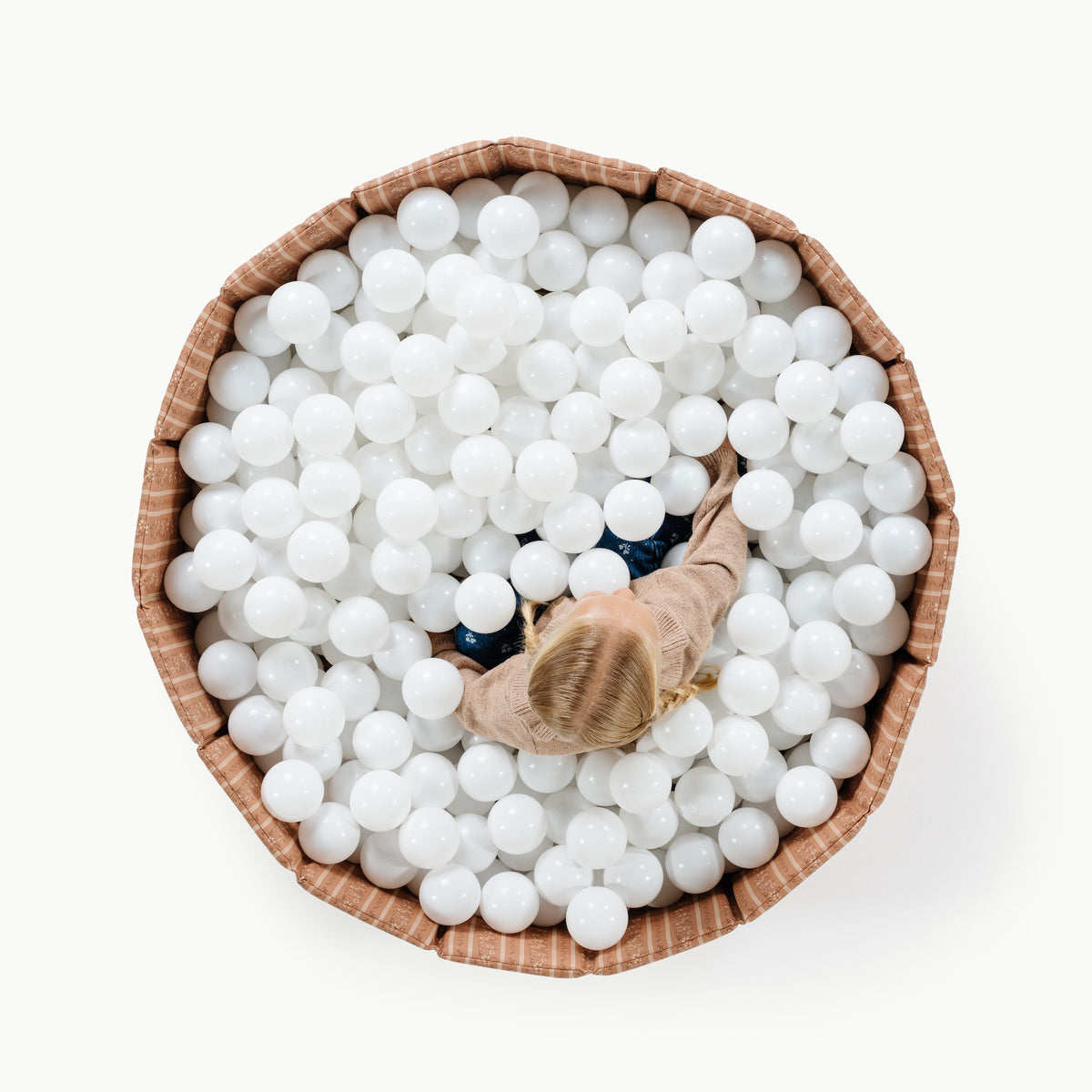 Floral Stripe@Child playing in a soft ball pit designed for babies and toddlers