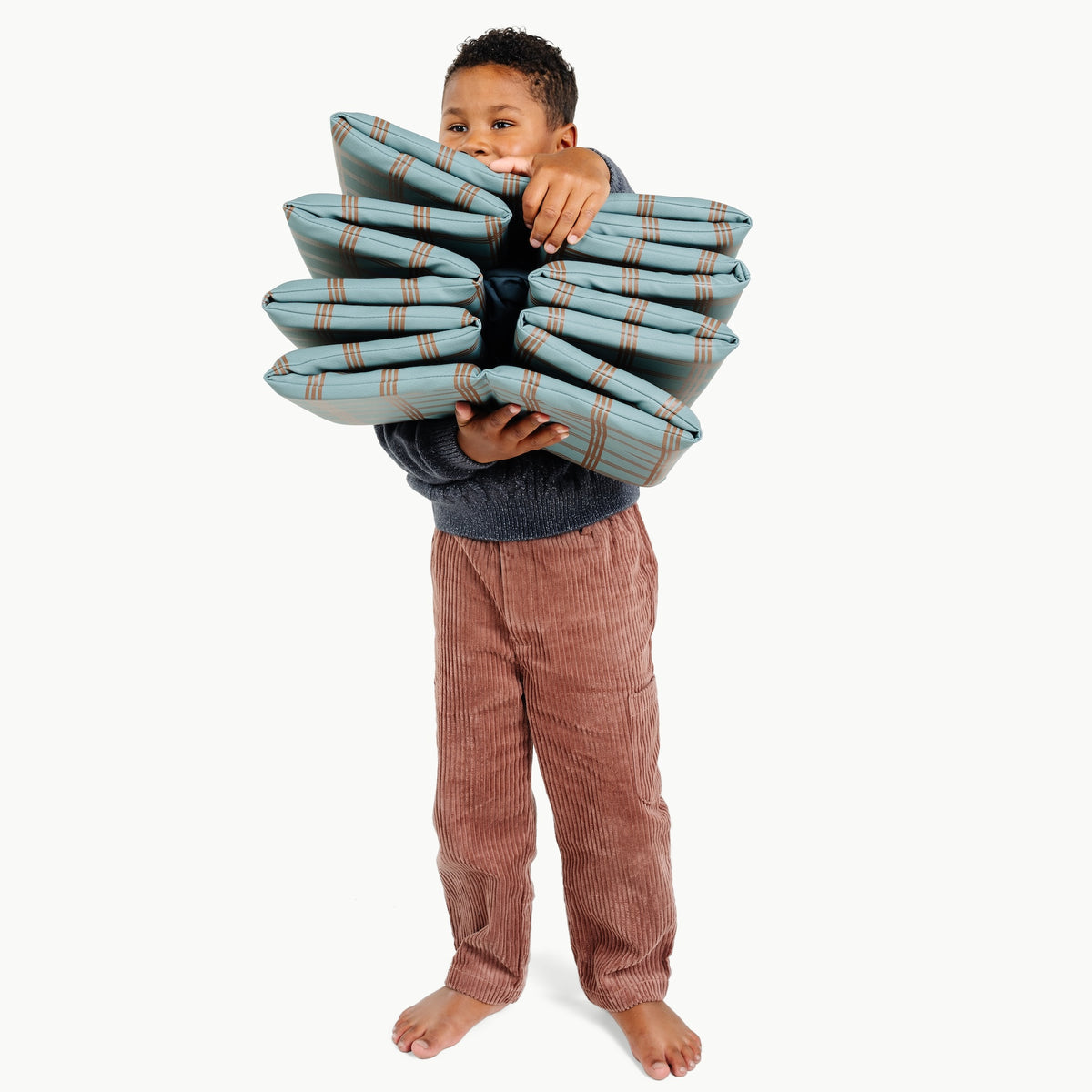 Rustic Plaid@kid holding the ball pit folded up