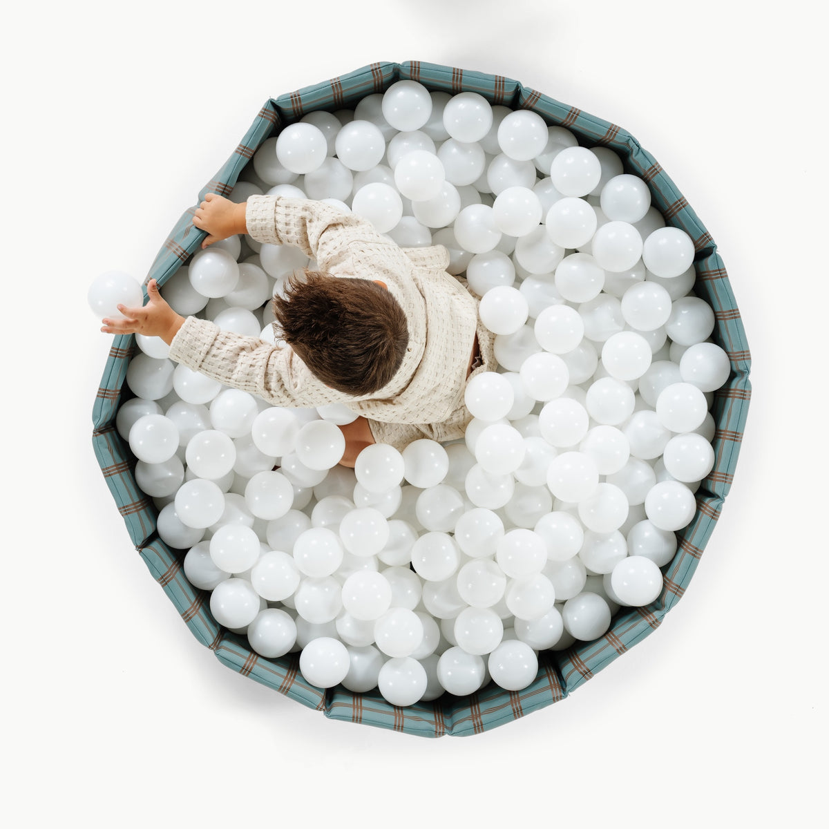 Rustic Plaid@Child playing in a soft ball pit designed for babies and toddlers