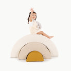 Ivory • Millet • Saffron@little girl playing on an arc playset