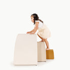 Ivory • Millet • Saffron@little girl playing on an arc playset