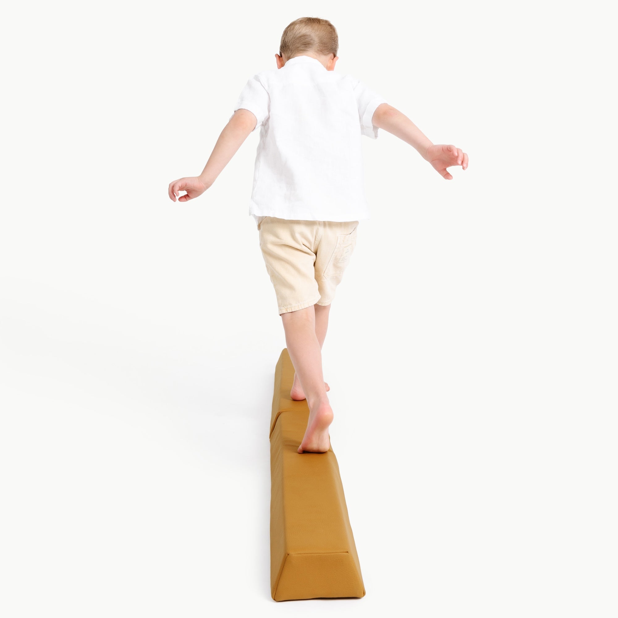 Saffron@boy playing on the balance beam