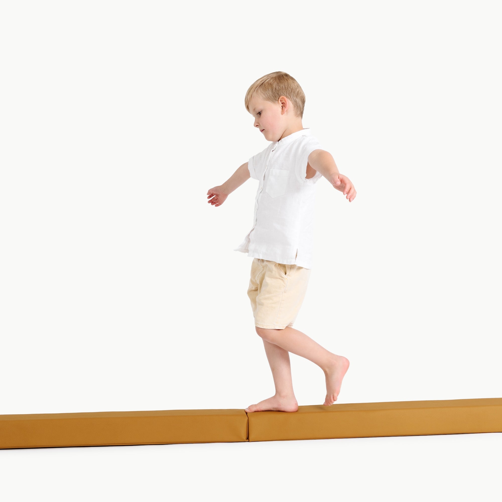 Saffron@boy playing on the balance beam