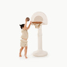 Ivory@little girl playing with ivory basketball hoop