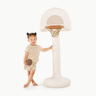 Ivory@little girl playing with ivory basketball hoop with ball