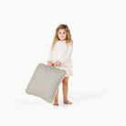 Stone Stripe / Square@Little girl holding the Stone Stripe Mini Square Floor Cushion