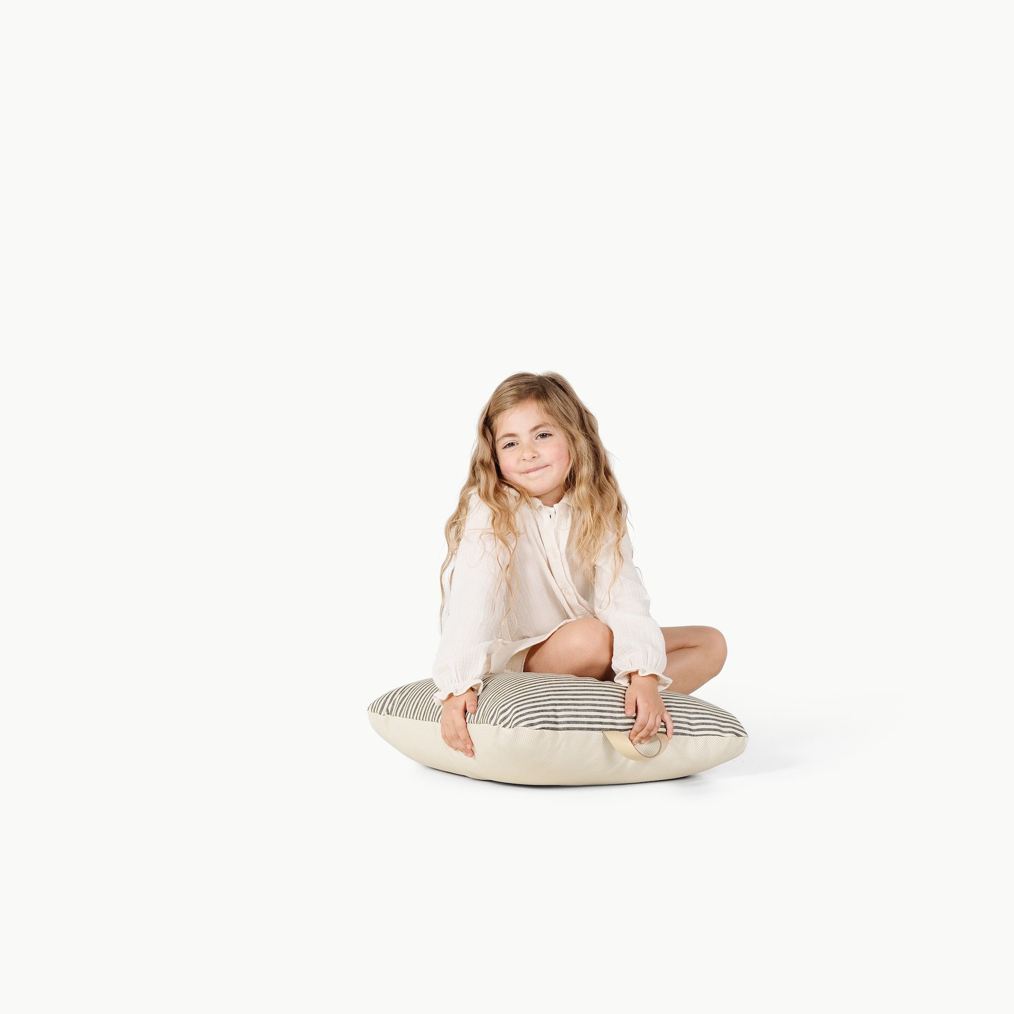 Stone Stripe / Square@Little girl sitting on the Stone Stripe Mini Square Floor Cushion