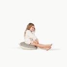 Stone Stripe / Circle@Little girl sitting on the Stone Stripe Mini Circle Floor Cushion