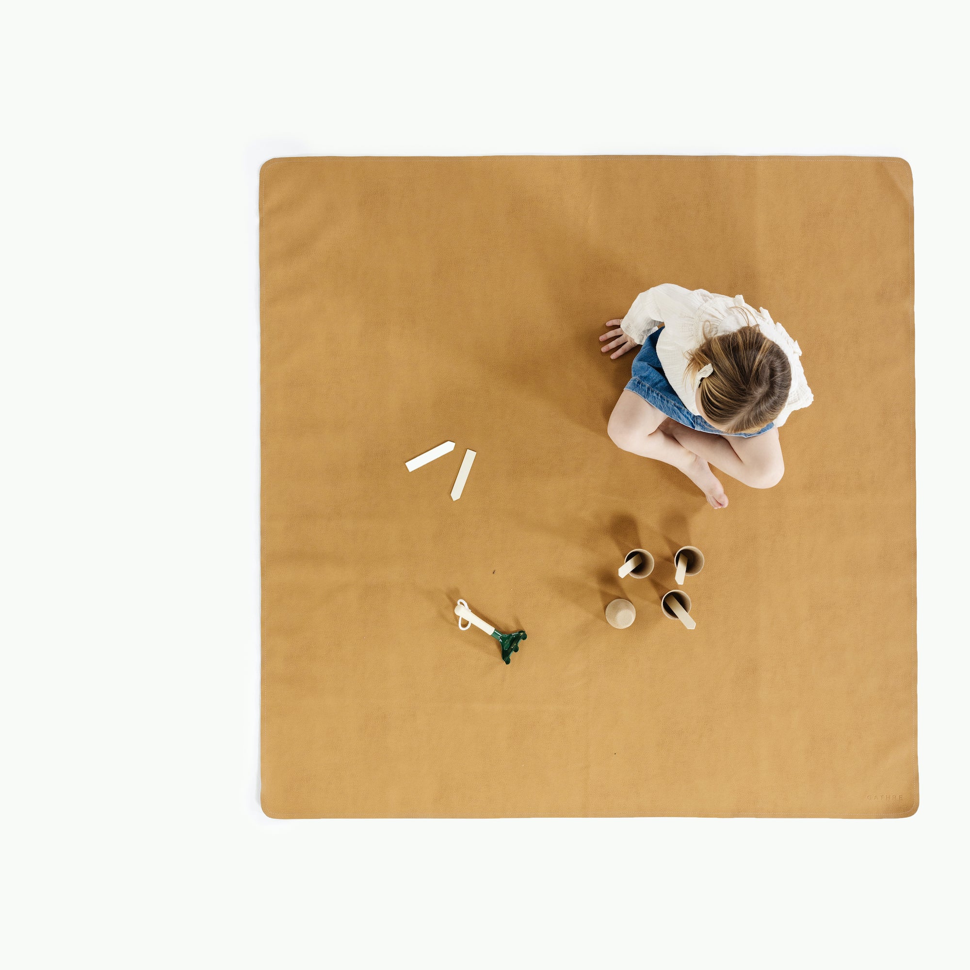 Tassel / Square@overhead of girl playing on mat