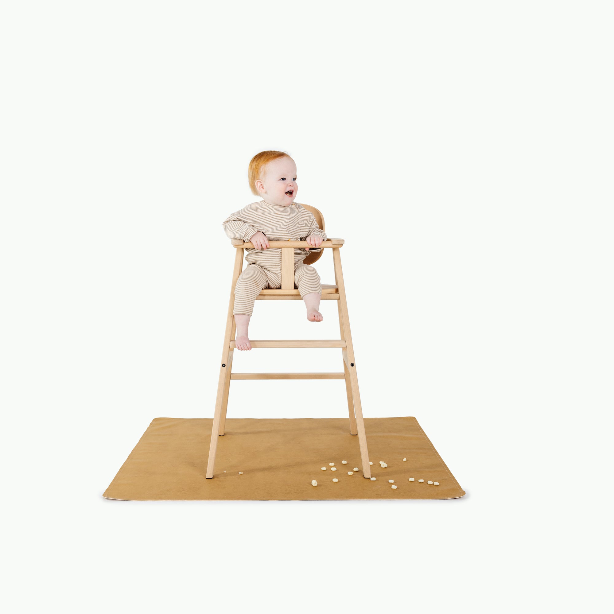 Tassel@baby in high chair on mat