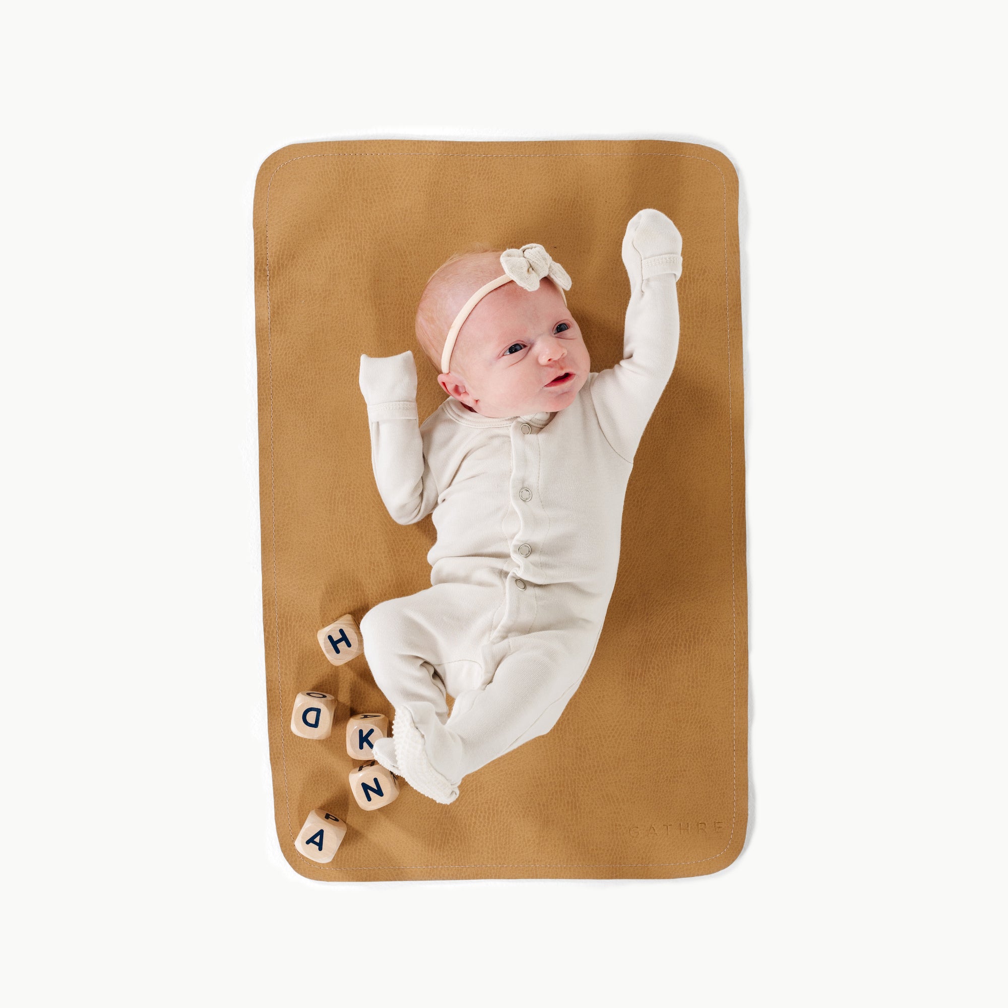 Tassel@overhead of baby laying on the tassel micro mat