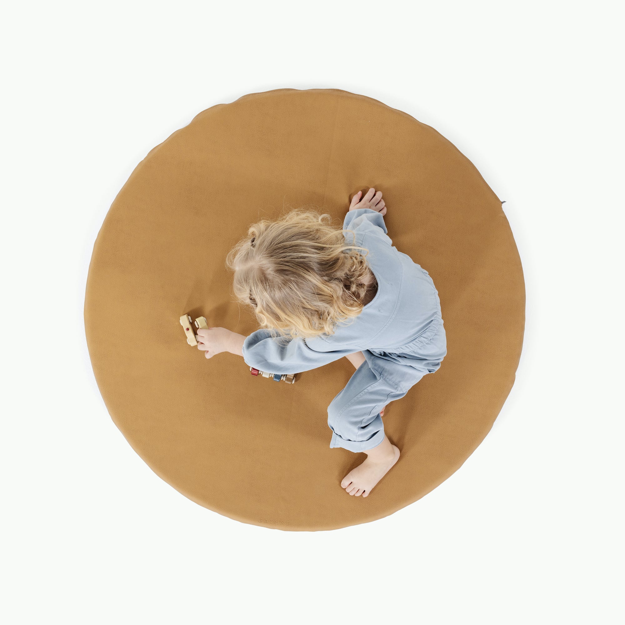 Tassel / Circle@overhead of little girl playing on padded mat