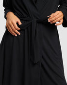 Black@woman wearing a black cozy earth robe
