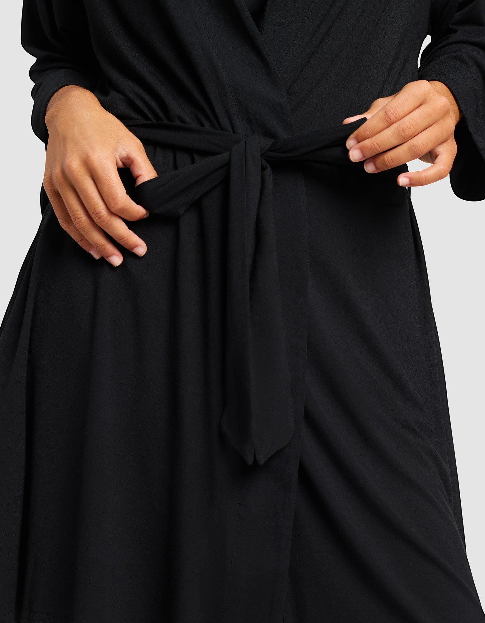 Black@woman wearing a black cozy earth robe