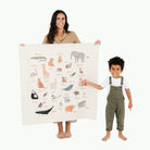 Animal Alphabet@Woman holding the Animal Alphabet Mini Mat with little boy standing to the side