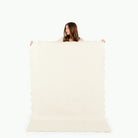 Ivory Scallop / 6 Foot@woman holding up ivory scallop tablecloth