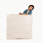 Bloom (on sale) / Square@Kid holding the Bloom Square Floor Cushion