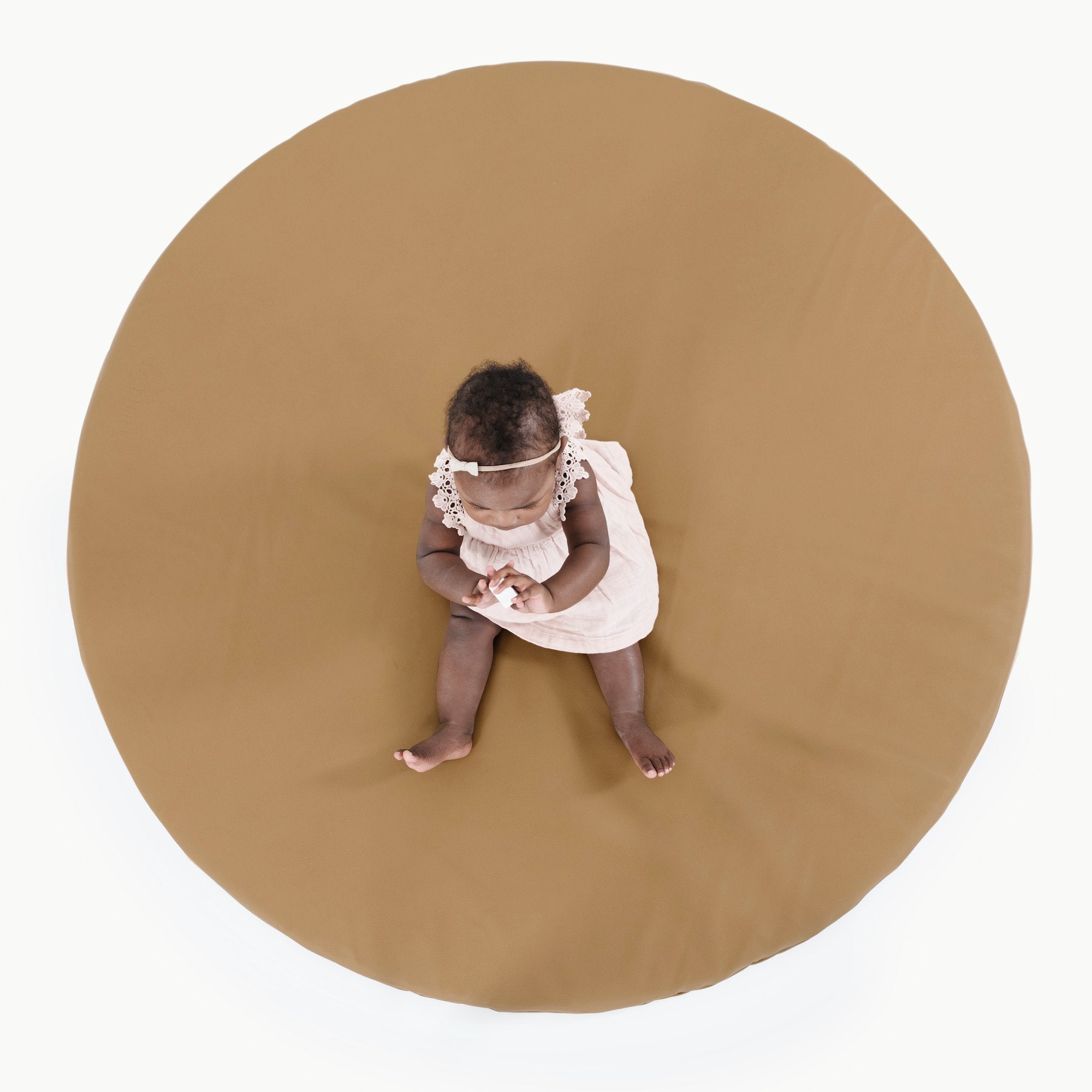 Camel@Overhead of baby sitting on Padded Midi Circle