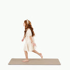Ember (on sale)@girl walking across ember medium home mat
