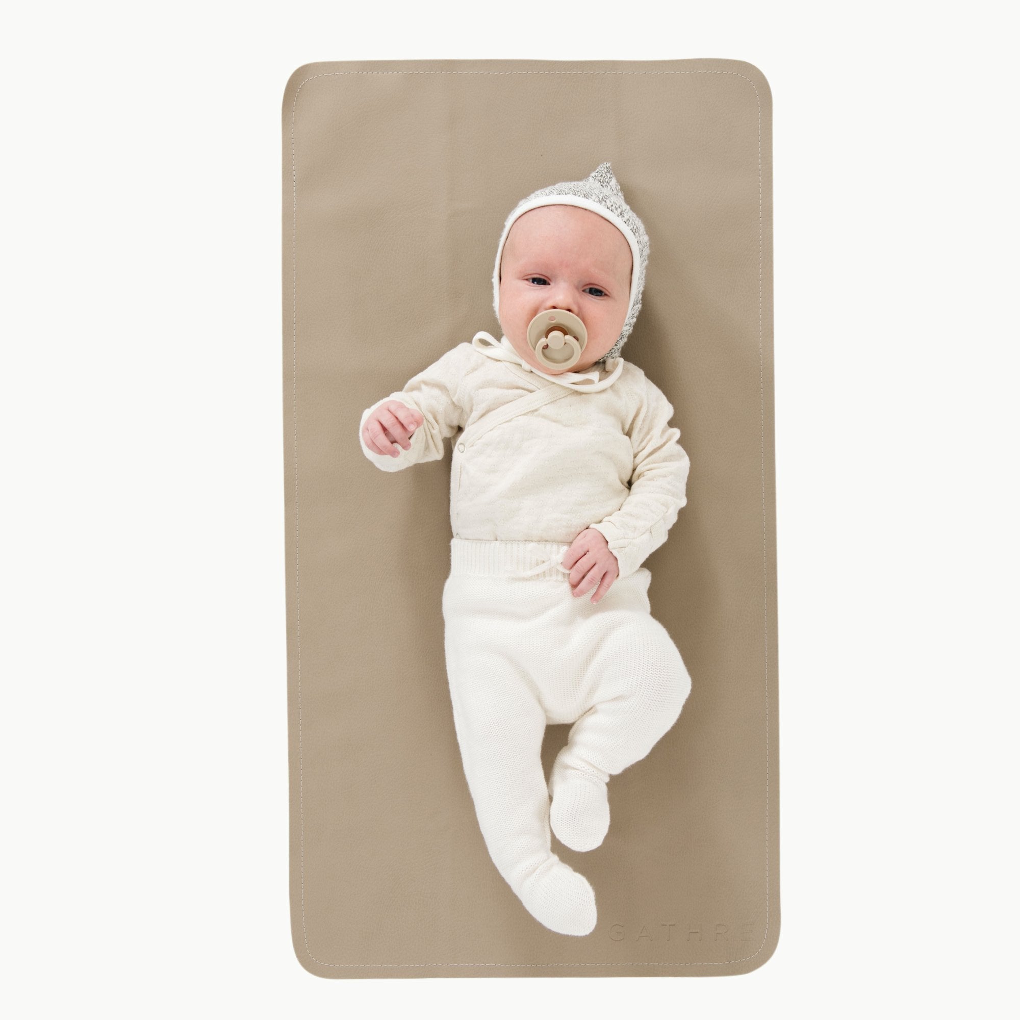 Ember (on sale)@Overhead of baby laying on the Ember Micro+ Mat