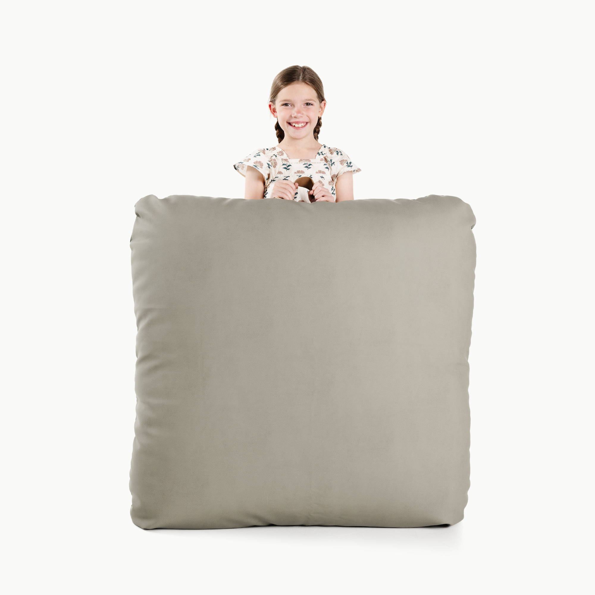 Fern (on sale) / Square@Kid holding the Fern Square Floor Cushion