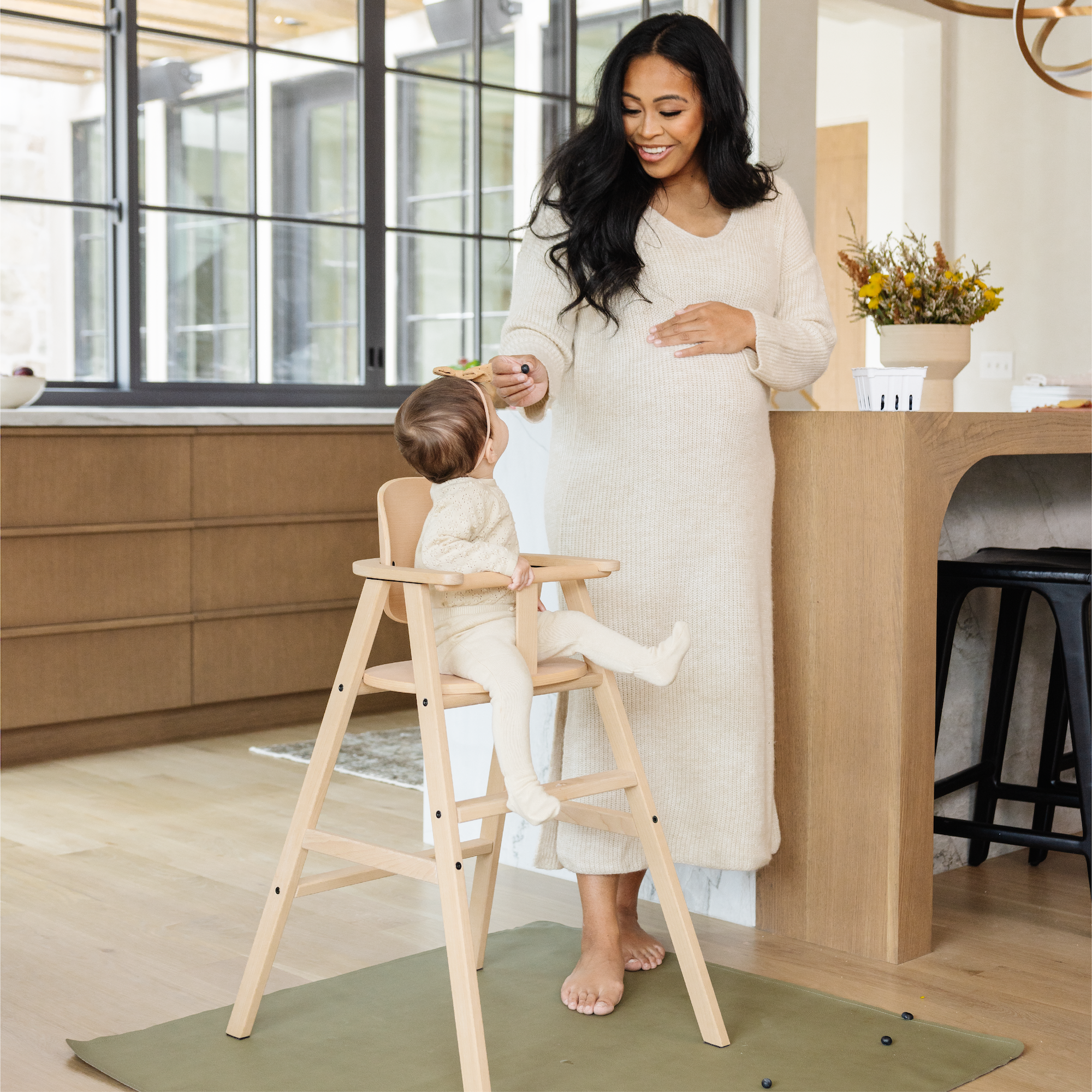 Fern (on sale)@Fern Mini Mat shown under highchair with mom and baby