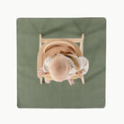 Thyme@Overhead of baby in a high chair on a Thyme Mini Mat