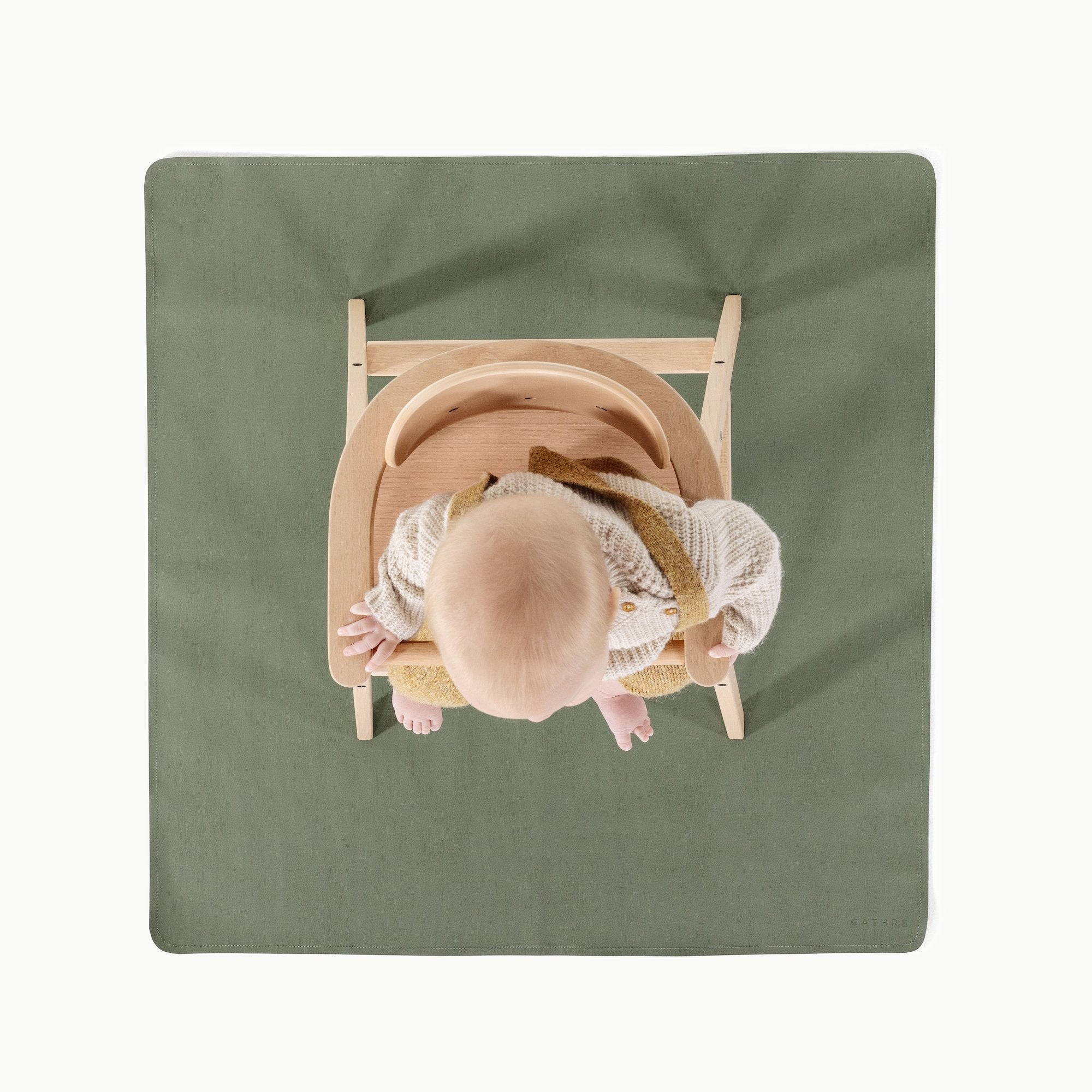 Thyme@Overhead of baby in a high chair on the Thyme Mini Mat