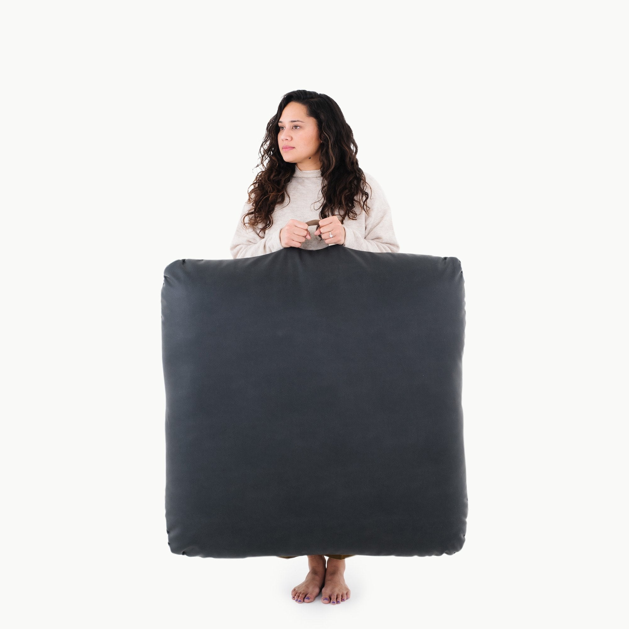 Raven / Square@Woman holding the Raven Square Floor Cushion