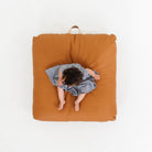 Ginger (on sale) / Square@Overhead of kid sitting on the Ginger Square Floor Cushion