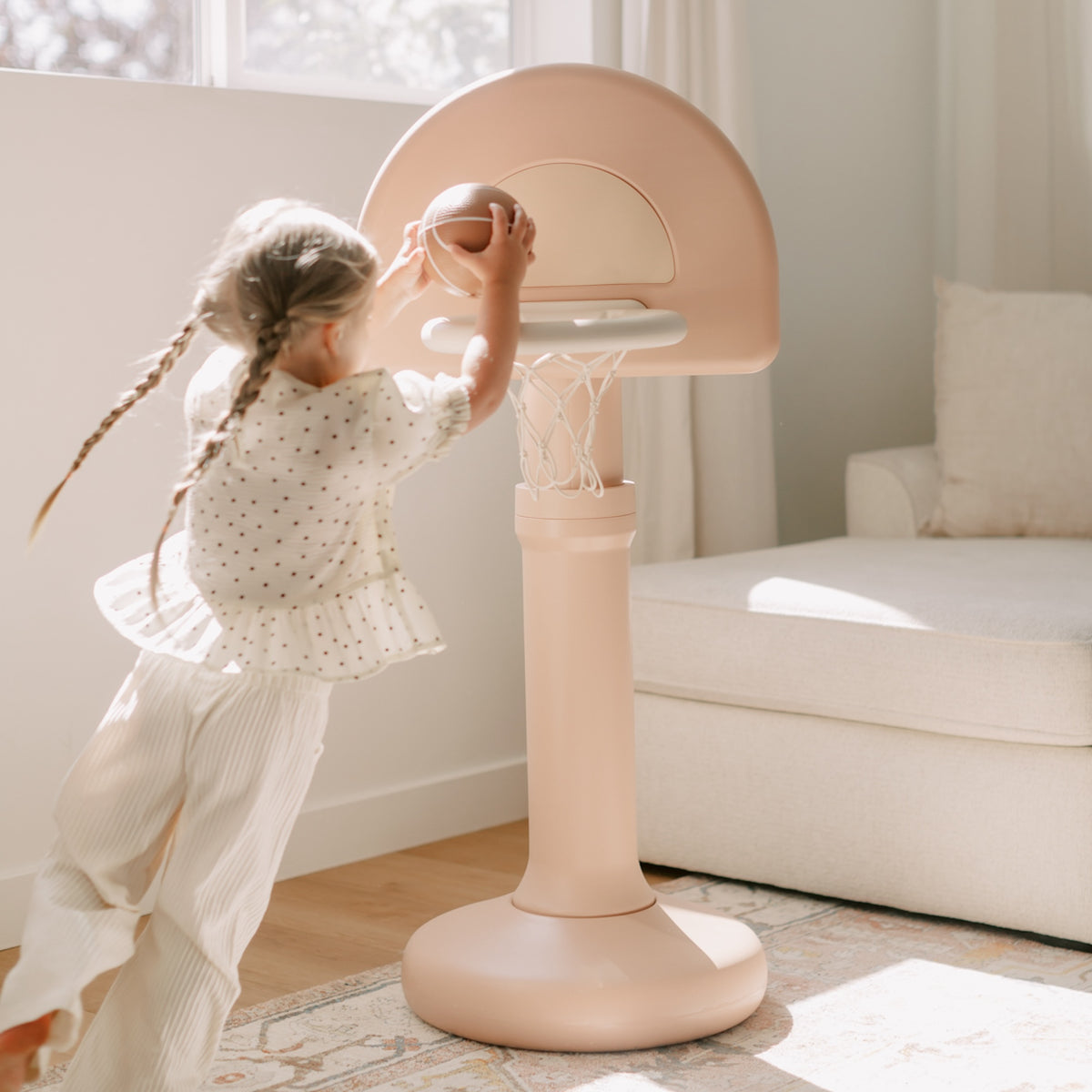 Tulle@Toddler playing with Toddler basketball hoop designed for indoor and outdoor play