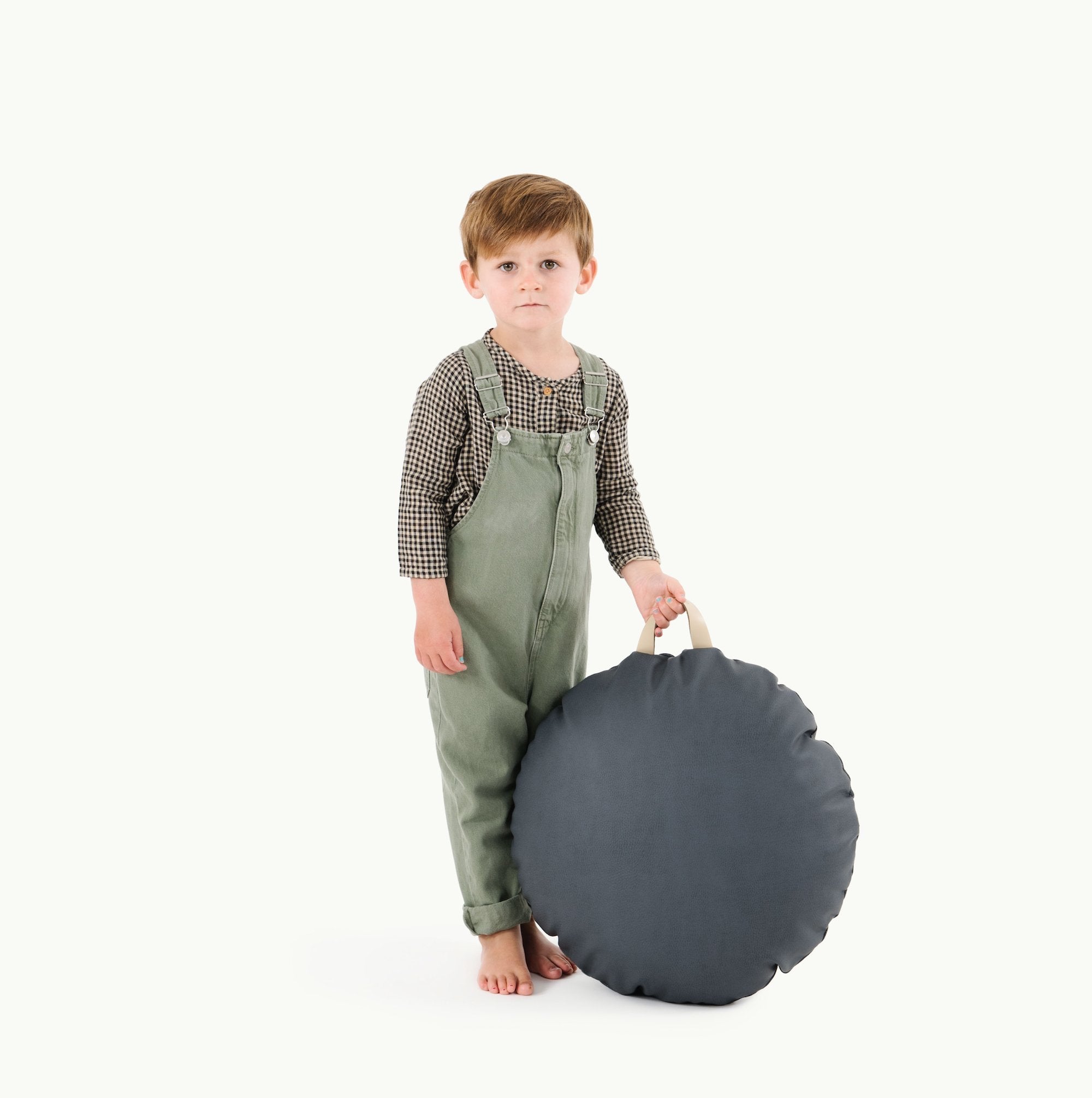 Nightfall (on sale) / Circle@Kid holding the Nightfall Circle Mini Floor Cushion