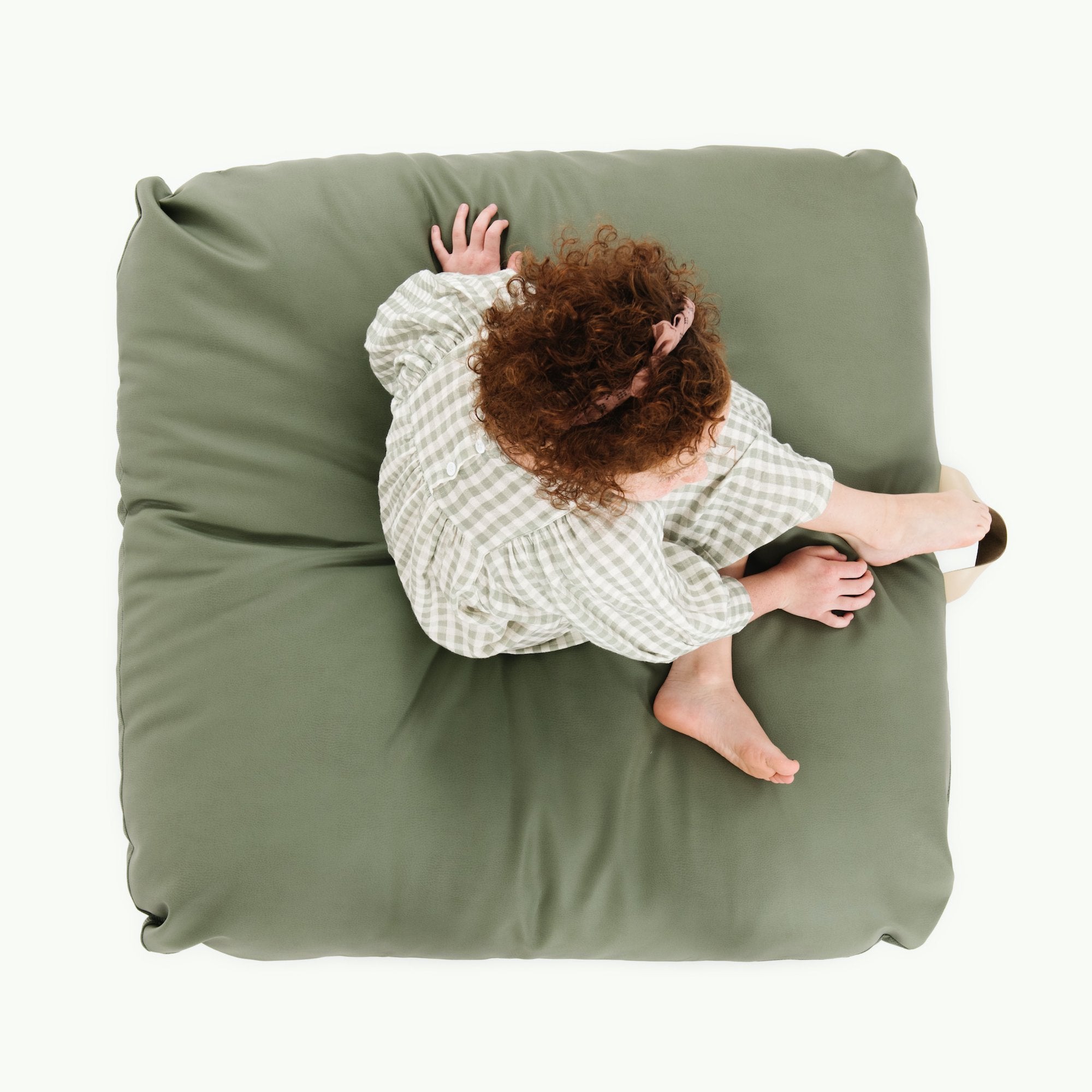 Thyme / Square@Overhead of kid sitting on the Thyme Square Floor Cushion