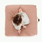 Sienna (on sale) / Square@Overhead of kid sitting on the Sienna Square Floor Cushion