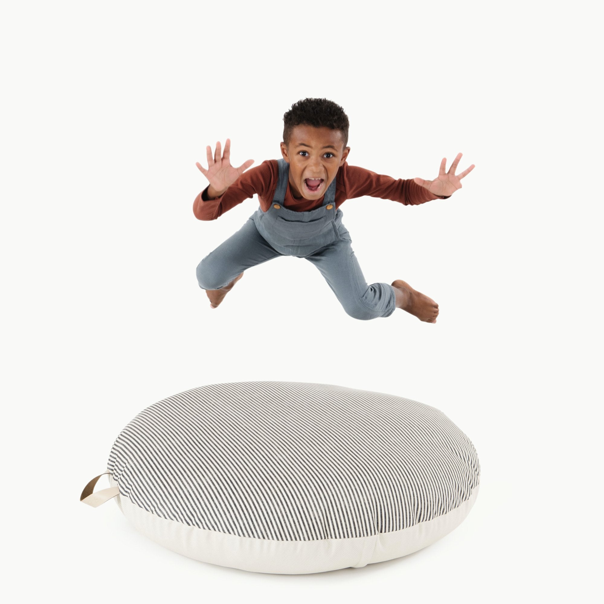 Stone Stripe / Circle@Kid jumping on the Stone Stripe Circle Floor Cushion