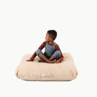 Untanned  (on sale) / Square@Kid sitting on the Untanned Square Floor Cushion
