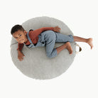 Stone Stripe / Circle@Overhead kid sitting on the Stone Stripe Circle Floor Cushion