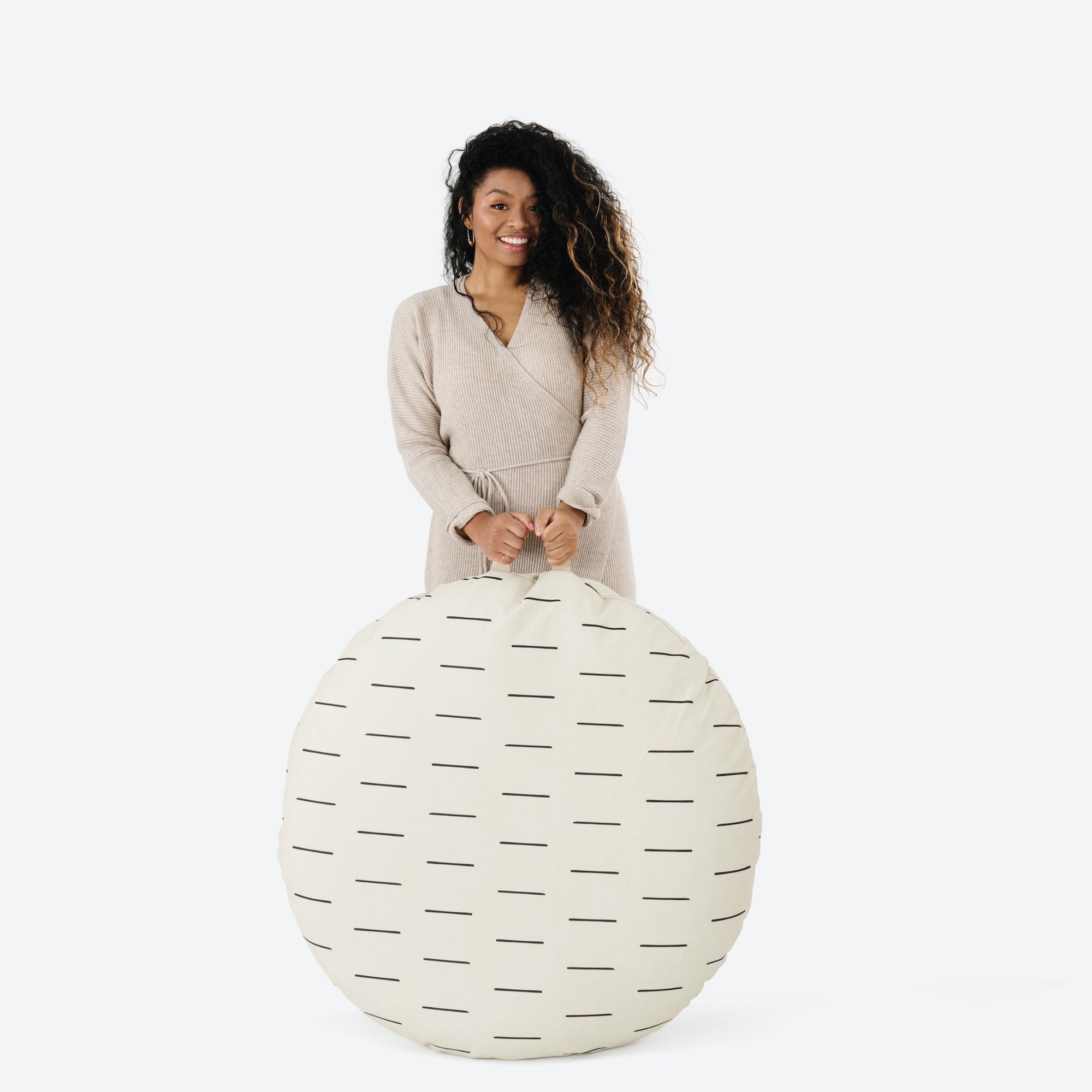 Blanc Dash (on sale) / Circle@Woman holding the Blanc Dash Circle Floor Cushion