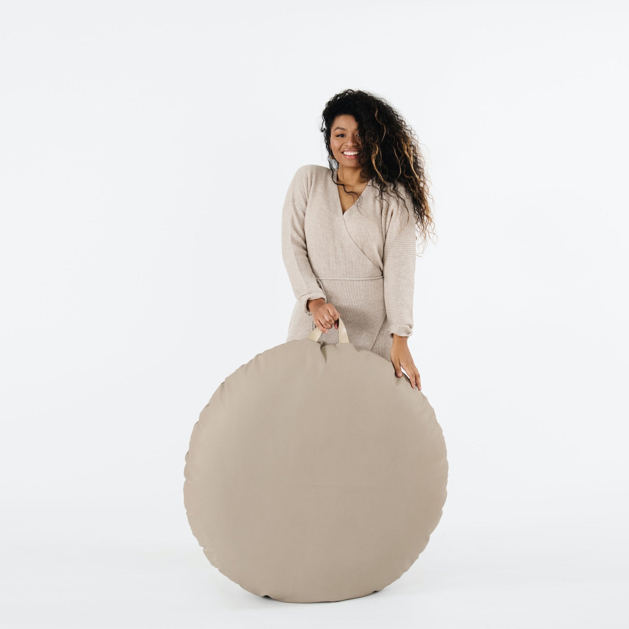 Ember (on sale) / Circle@Woman holding the Ember Circle Floor Cushion