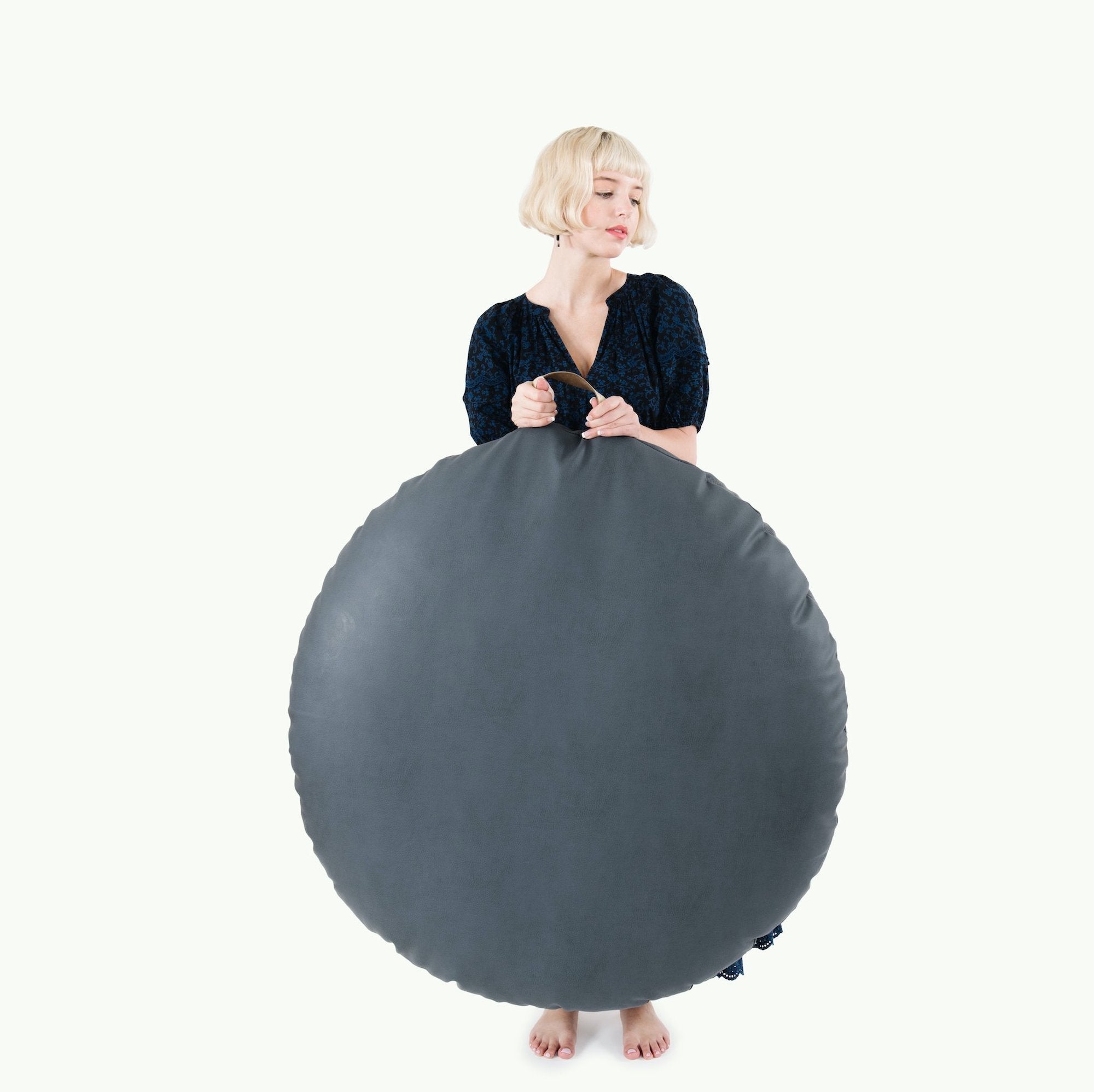 Nightfall (on sale) / Circle@Woman holding the Nightfall Circle Floor Cushion