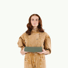 Thyme (on sale)@Woman holding a folded Thyme Midi+ Mat
