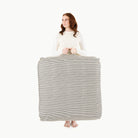 Stone Stripe / Square@Woman holding the Stone Stripe Square Floor Cushion
