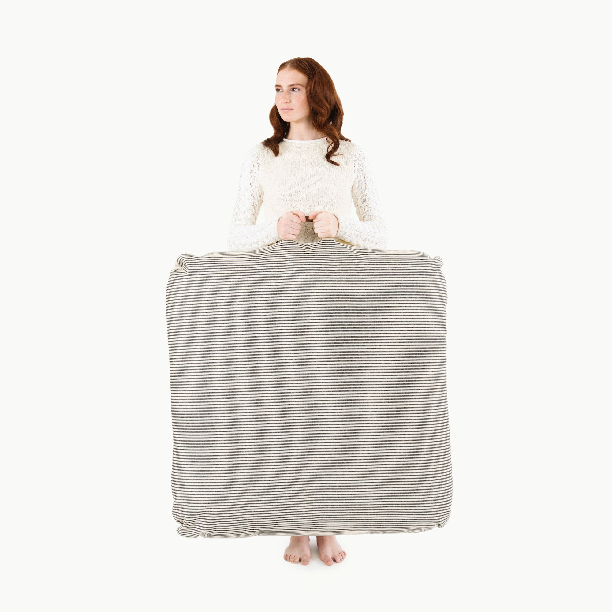 Stone Stripe / Square@Woman holding the Stone Stripe Square Floor Cushion