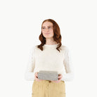 Stone Stripe@Woman holding a folded Stone Stripe Mini Mat