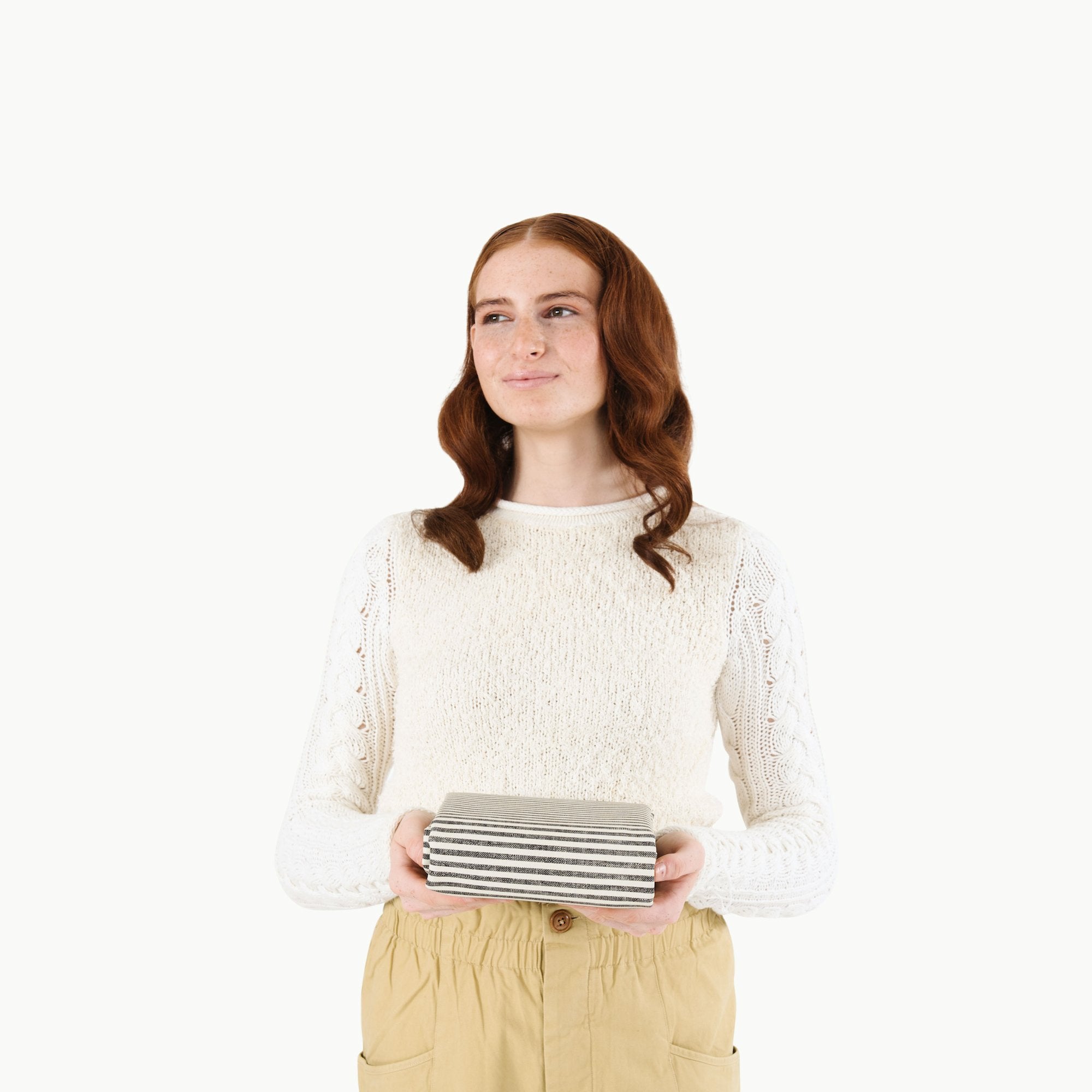 Stone Stripe@Woman holding a folded Stone Stripe Mini Mat