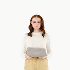 Stone Stripe@Woman holding a folded Stone Stripe Maxi Mat